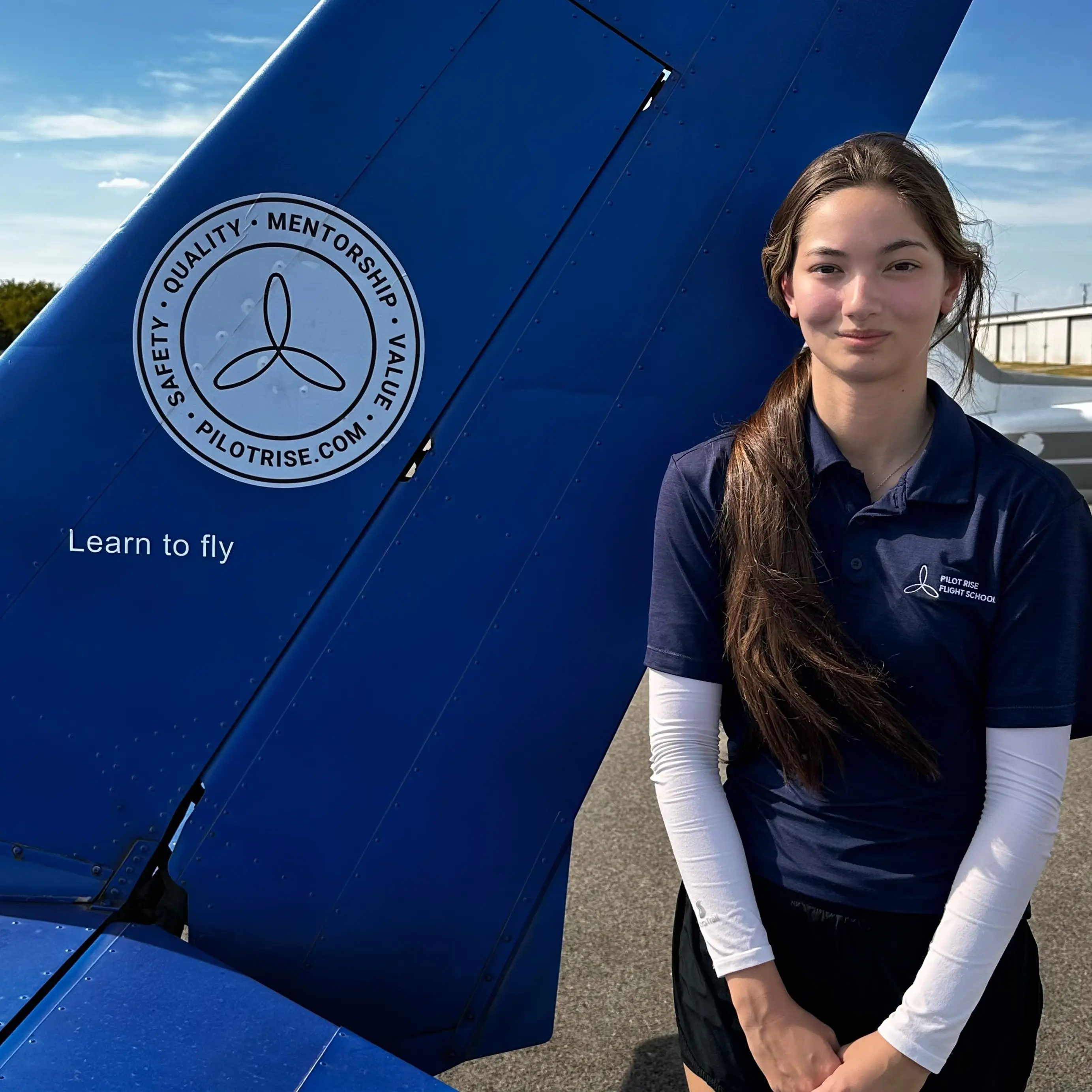 Jayna Moore, Pilot Rise flight instructor, beside a Pilot Rise aircraft at Hicks Airfield