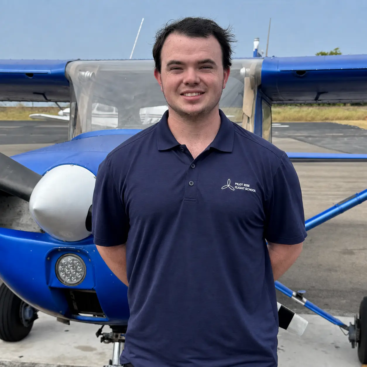 Liam O'Flaherty, flight instructor at Pilot Rise Fort Worth, standing by a Cessna