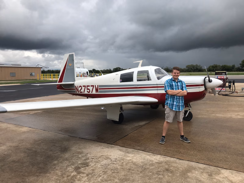 Michael Forseth as a young flight instructor beside a Mooney