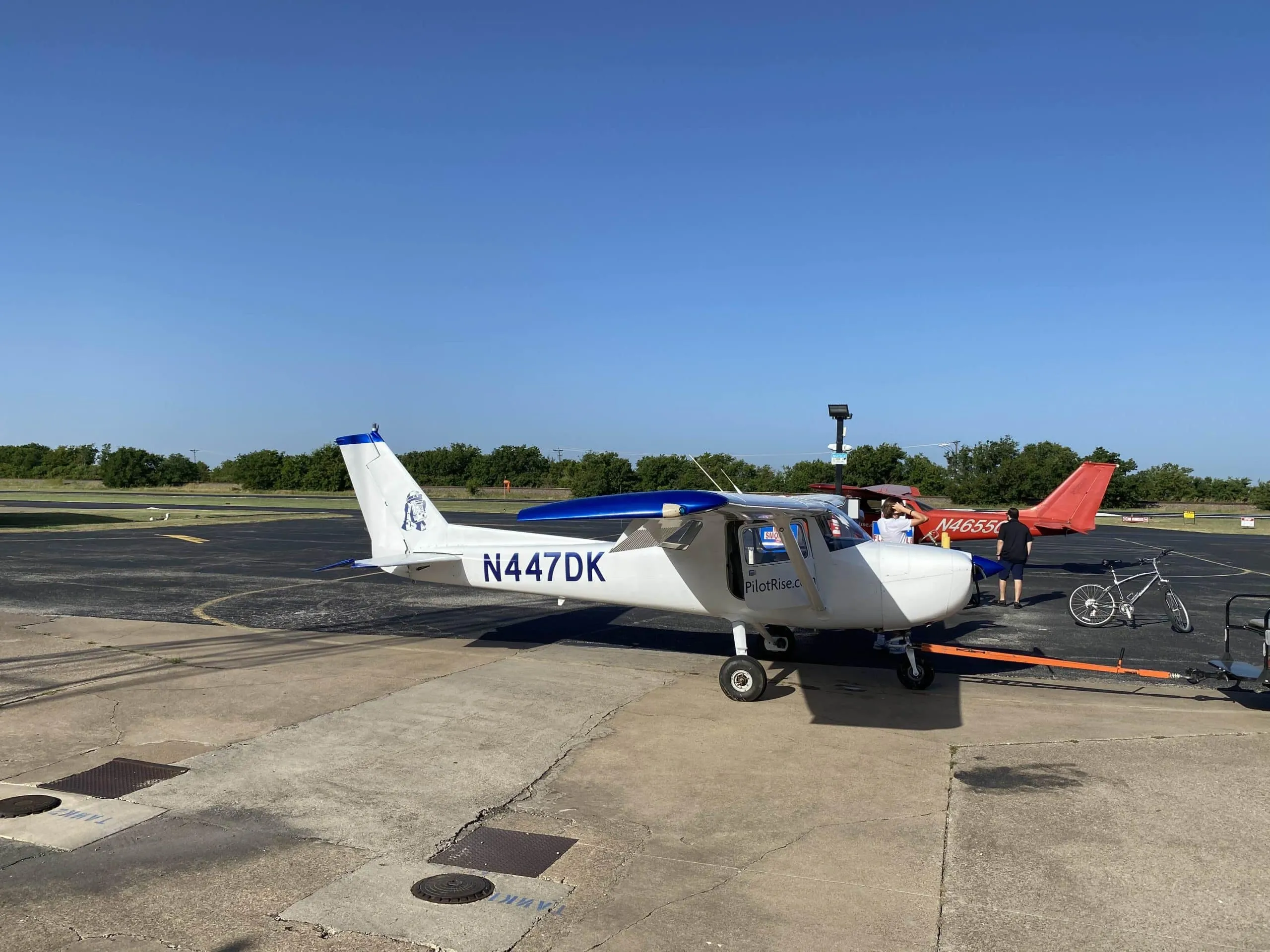 Pilot Rise Cessna 150M N447DK dusty ramp view