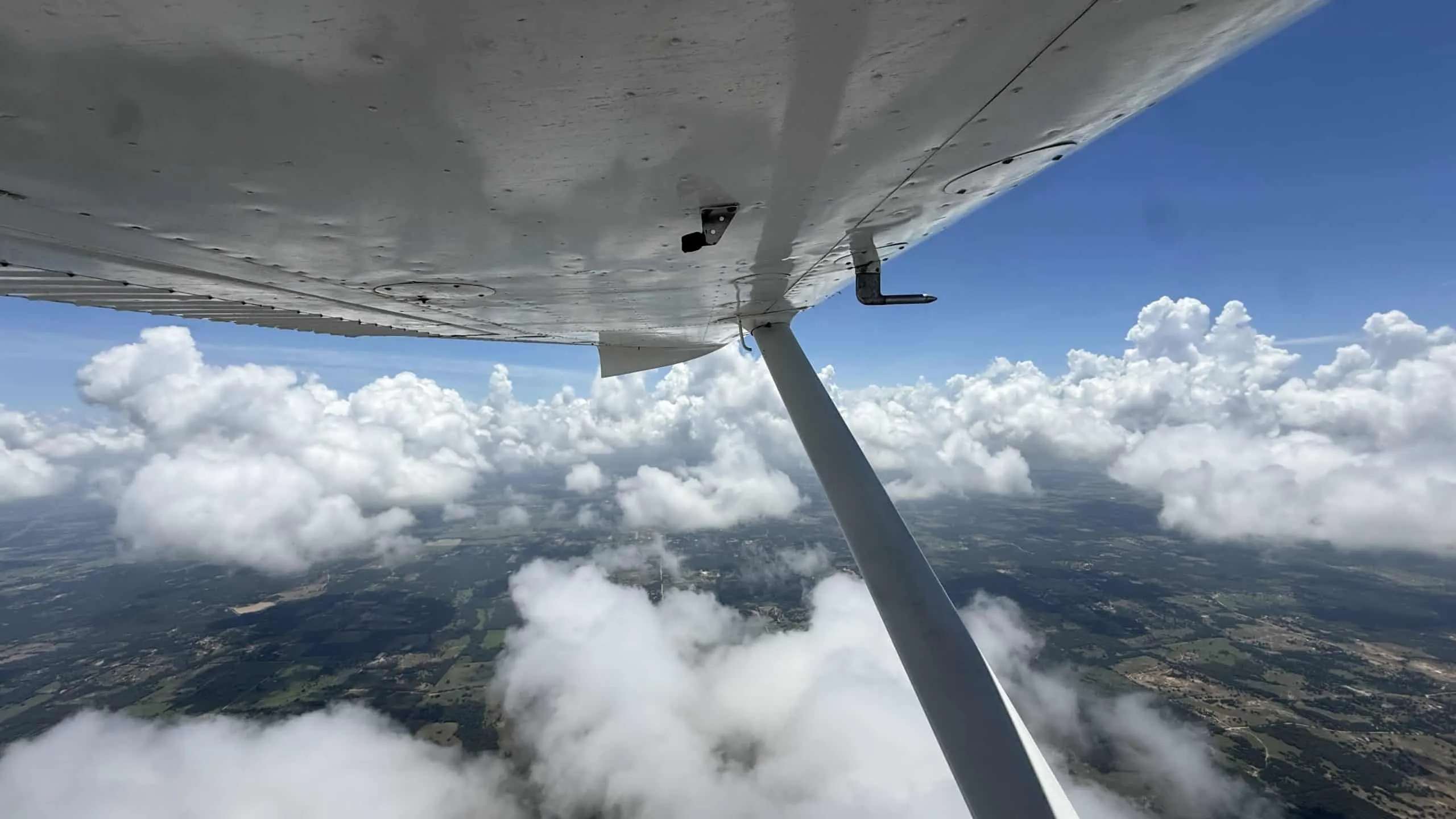 Pilot Rise aircraft wing over Dallas-Fort Worth for the how much does it cost to become a pilot guide