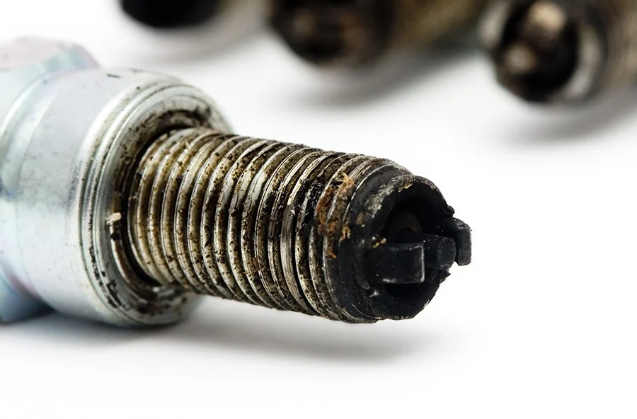 Aircraft spark plug coated with combustion deposits