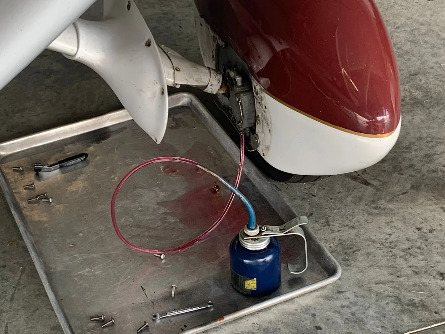 Maintenance personnel servicing aircraft hydraulic fluid