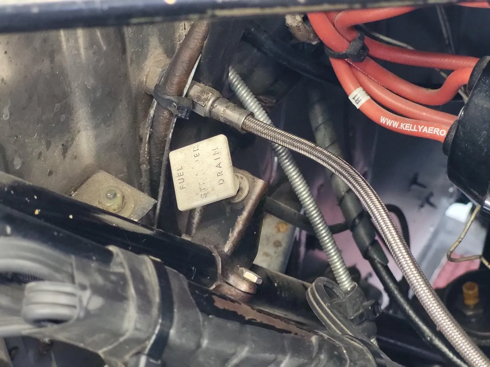 Fuel strainer control inside engine cowling