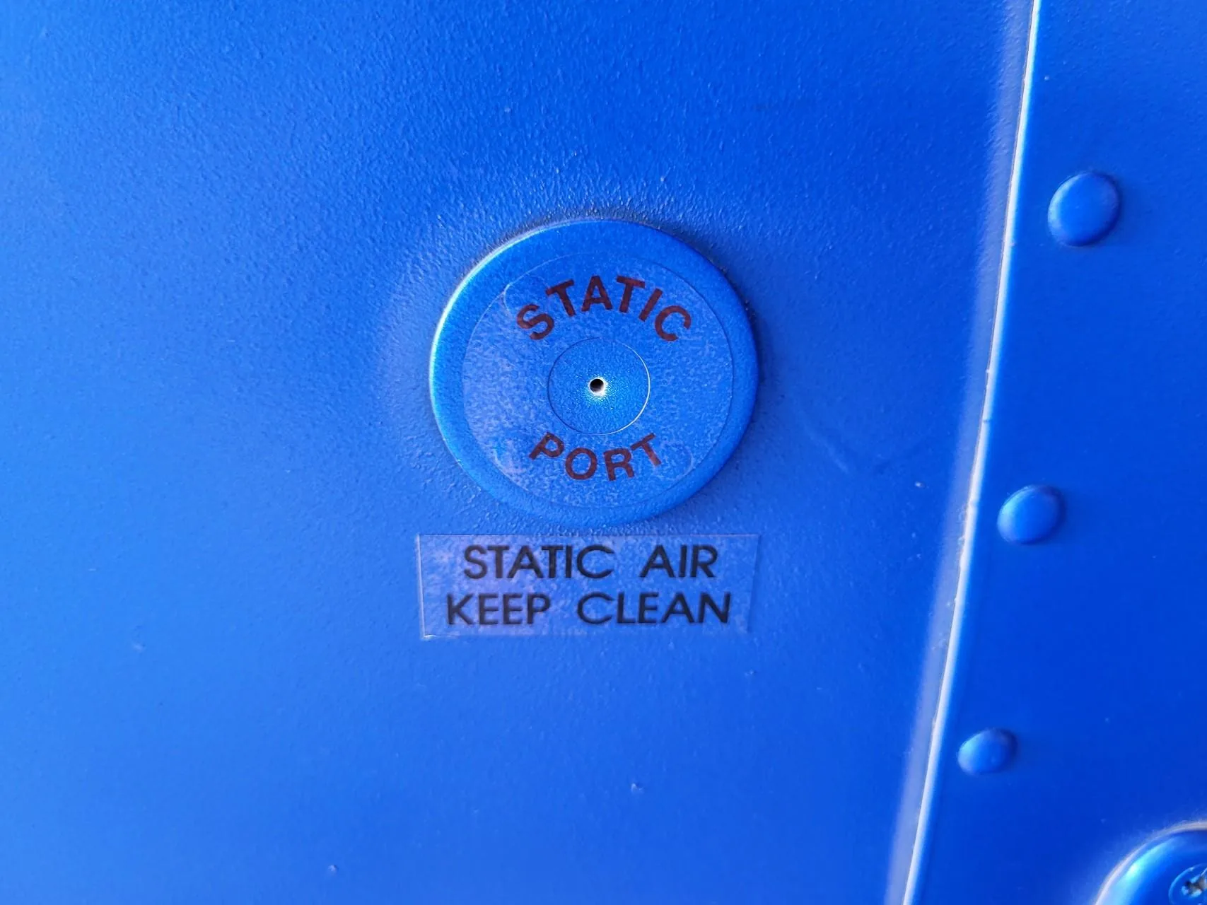 Static port on the side of a Cessna fuselage